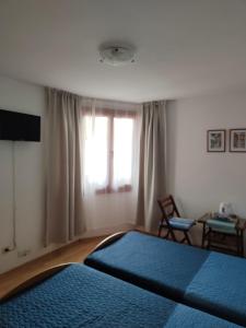 a bedroom with two beds and a window at Guest Rooms Melsambria in Nesebar
