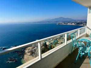 Un balcón con sillas y vista al mar. en VISTAMAR COSTAHORIZONTE CONCON, en Concón