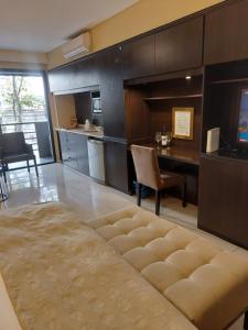 a large living room with a kitchen and a table at Comfortable Modern Apartment in Buenos Aires
