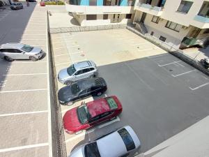 a group of cars parked in a parking lot at Apartament RAMI Mamaia Nord in Mamaia Nord