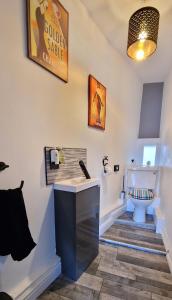 a bathroom with a sink and a toilet at The Penthouse NY Loft Apartment in Barmouth