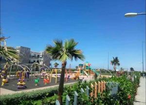 an amusement park with a roller coaster and a playground at Nice Apartment in Blanca Beach in Sidi Rahal