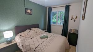 a bedroom with a bed and a window at Charmante maison au calme in Le Veurdre