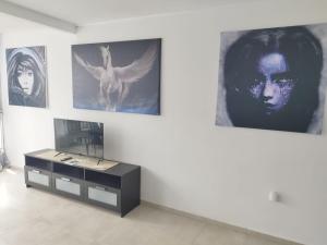 a room with a table and pictures on the wall at Apartment mit schöner Aussicht und Balkon in San Marcos