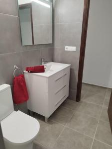 a bathroom with a white sink and a toilet at Apartment mit schöner Aussicht und Balkon in San Marcos +15 photos