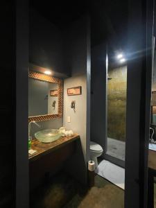 a bathroom with a sink and a toilet at San Carlos Surf Resort & Eco Lodge in San Carlos