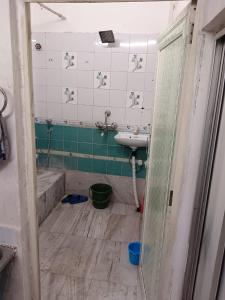 a bathroom with a sink and a sink at 2nd floor room in Kolkata