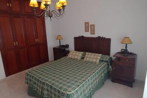 a bedroom with a bed and two night stands at Casa o Pontillón in Rabiño