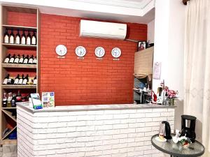 a restaurant with a brick wall with clocks on it at Tbil Inn Hotel in Tbilisi City
