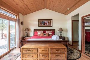 a bedroom with a large bed and a wooden ceiling at Lake Time Villa NEW Luxury with HOT TUB in Big Bear Lake