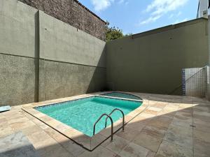 a swimming pool on a patio next to a wall at (103) Coastal seaside - Pebble in Pimenta