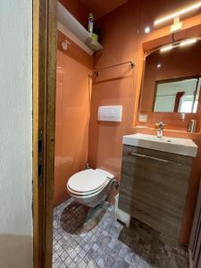 a bathroom with a toilet and a sink and a mirror at Althea Rooms in Florence