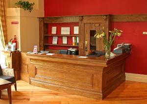 a cashier counter in a room with a red wall at Harding Hotel in Dublin