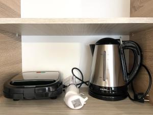 a coffee maker and a blender on a shelf at Armonia Guest House in Nea Roda