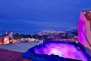 a view of a purple pool at night at Cottage Dolcevita by KlabHouse in Palau
