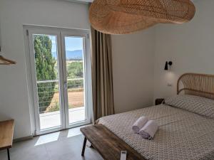 a bedroom with a bed and a large window at Agreen Country House in Olbia