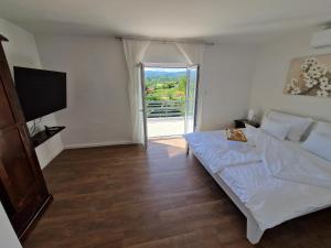 a bedroom with a bed and a large window at Villa Otto - Private Pool & Garden in Zagreb +69 photos