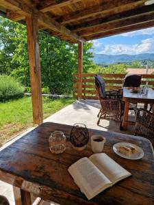 an open book on a wooden table on a patio at Villa Otto - Private Pool & Garden in Zagreb