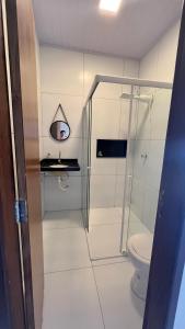 a bathroom with a shower and a toilet at RECANTO DAS ÁGUAS VILLE in Santo Amaro