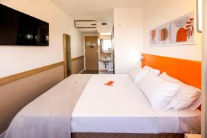 Postel nebo postele na pokoji v ubytování HUS Hotel MARINGA
