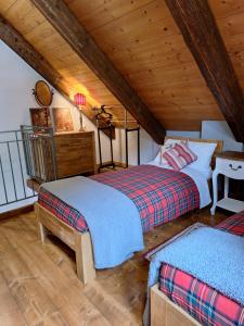 a bedroom with two beds in a attic at Locanda del Sasso Rooms in Crodo