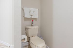 a white toilet in a bathroom with towels at Golf View - Elevator Accessible - Center Of Branson - FREE TICKETS INCLUDED - RL8-11A in Branson +18 photos