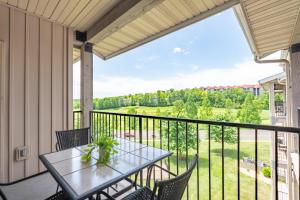 a balcony with a table and chairs and a view at Golf View - Elevator Accessible - Center Of Branson - FREE TICKETS INCLUDED - RL8-11A in Branson