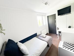 niewielka sypialnia z łóżkiem i stołem w obiekcie Pokoje Gościnne Przy Molo w mieście Gdynia