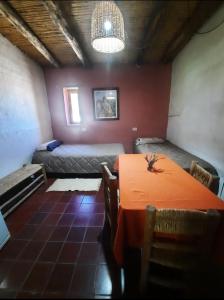 a room with a table and a bed in it at Posta Kamak Eco Posada Rural in Bella Vista