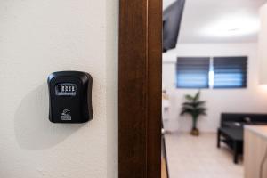 a black electrical switch on a wall in an office at BK Apartment Semi-Basement in Néa Khilí