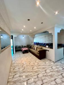 a large living room with a couch and a tile floor at M'a Raffiné appartement 2 in Casablanca