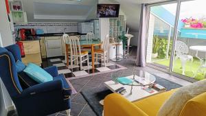 a living room with a table and a kitchen at ATTIC BAY - Cozy Stay with Sea View in Câmara de Lobos