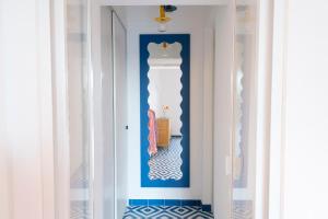 a hallway with a blue and white wall at o' mar - Amalfi Coast Suite in Praiano