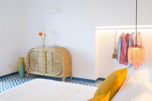 a room with a bed and a rack of clothes at o' mar - Amalfi Coast Suite in Praiano