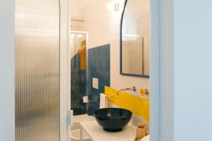 a bathroom with a black bowl sink and yellow tiles at o' mar - Amalfi Coast Suite in Praiano
