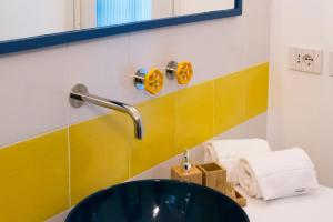 a bathroom with a green sink and a mirror at o' mar - Amalfi Coast Suite in Praiano
