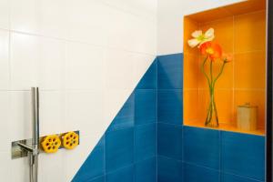 a bathroom with a vase with a flower in it at o' mar - Amalfi Coast Suite in Praiano