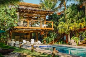 a villa with a swimming pool and a resort at Flat Camburi in Camburi