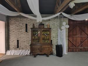 ein Holzschrank in einem Zimmer mit Ziegelwand in der Unterkunft Dolistówka in Goniądz