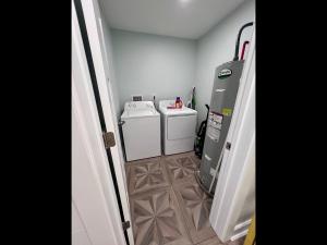 a laundry room with two washes and a washer at Boston Commons Penthouse Condo in Myrtle Beach