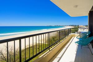 a balcony with a view of the beach at Pelican Sands Beach Resort in Gold Coast