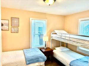 a bedroom with two bunk beds and a window at Bill's Apartments in Ocean City