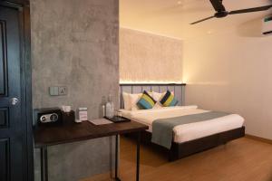 a bedroom with a bed and a desk with a speaker at Zinnia Maafushi in Maafushi +61 photos