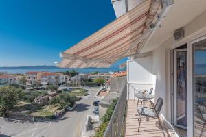 a balcony with a view of a street at Apartments Nina M in Baška Voda