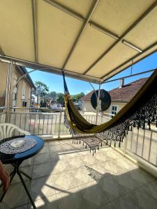 a hammock on the balcony of a house at Vila Nada Apartment in Vrnjacka Banja in Vrnjačka Banja