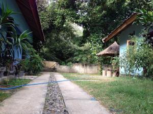 a garden with a hose hooked up to a house at Sawe Homestay in Kuta Lombok
