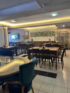 a dining room with tables and chairs in a restaurant at Maça Home in Edirne
