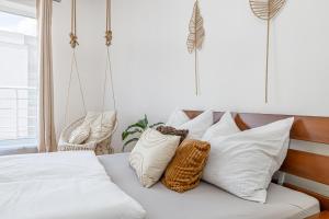 a bedroom with a bed with white pillows at Matteo - modern appartment with free parking in Bratislava
