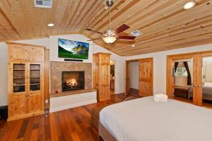 a bedroom with a bed and a fireplace at Minnow's Big Bear Estate 1.5 Acres W Game Room in Big Bear City +45 photos