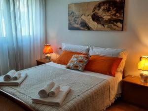 a bedroom with a bed with two towels on it at CASA DI IANA in Mestre